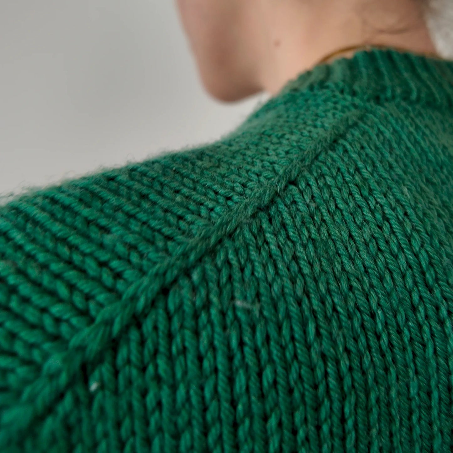 Close-up of decorative knitted shoulder braid on Chameleon Sweater by Atelier Castin