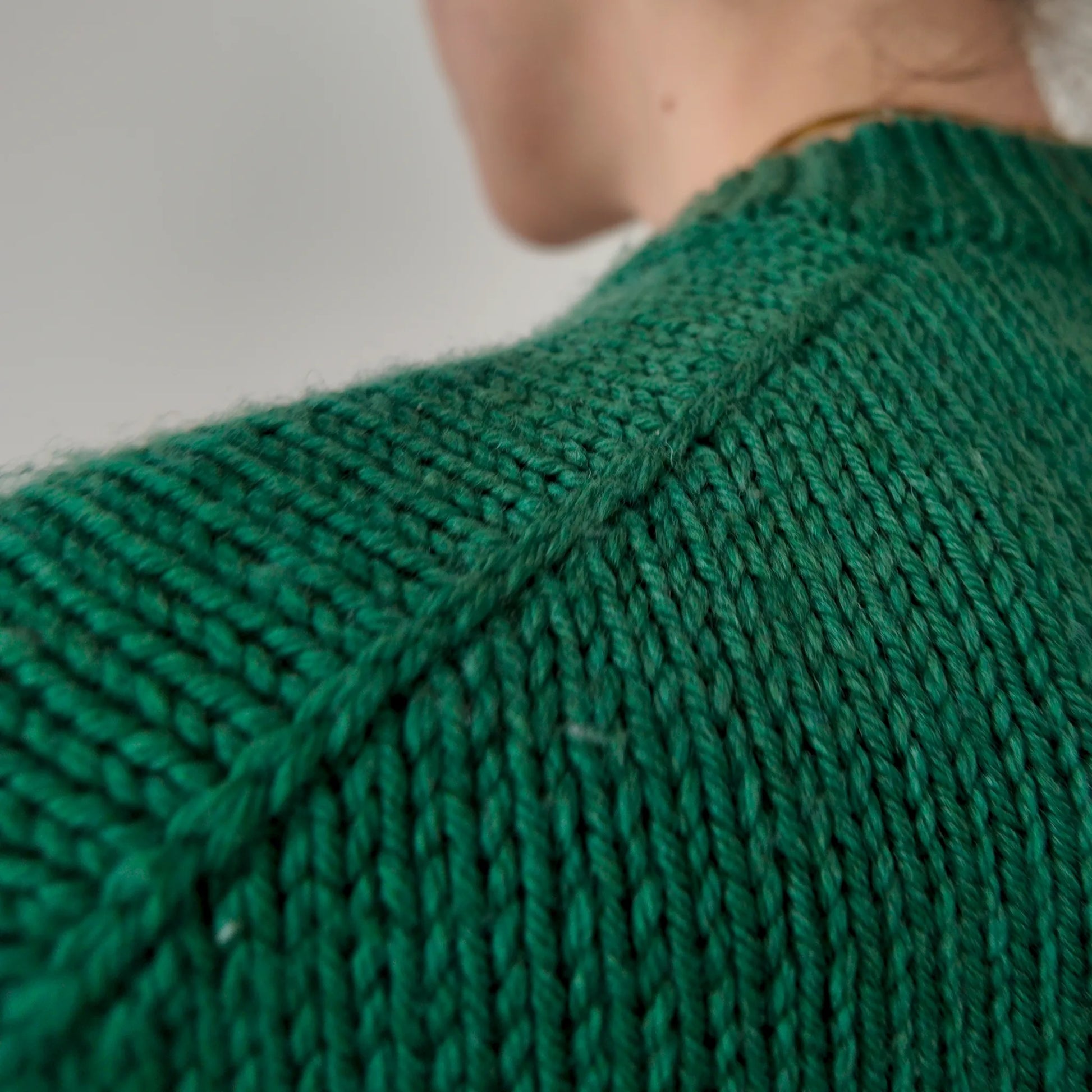 Close-up of decorative knitted shoulder braid on Chameleon Sweater by Atelier Castin