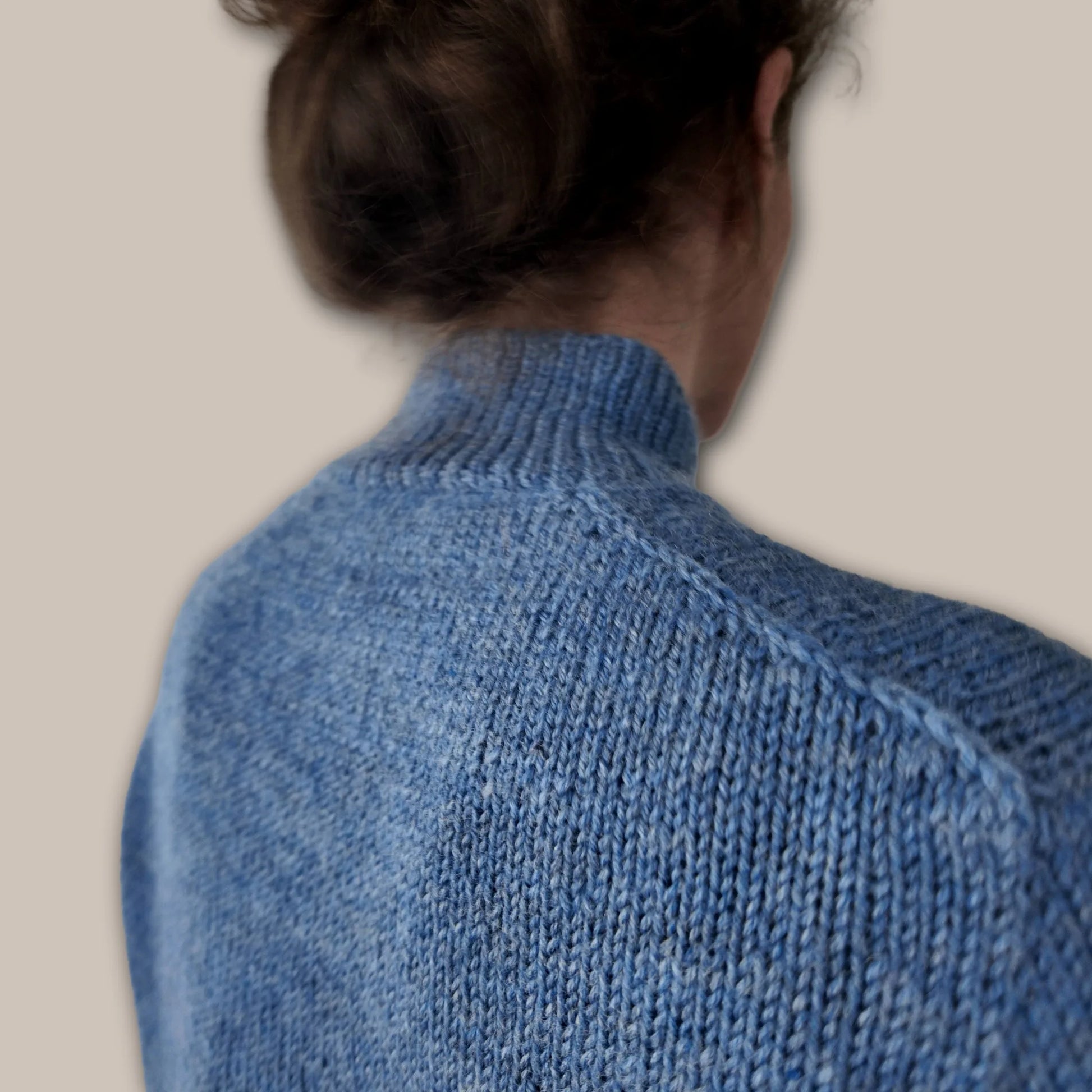 Close-up of decorative knitted shoulder braid on Chameleon Sweater by Atelier Castin mock neck version